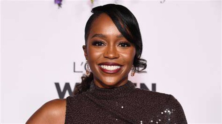 Aja Naomi King and her husband with her newborn son at Paris fashion